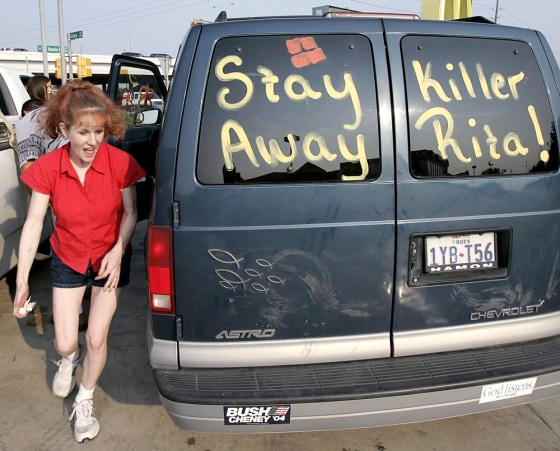 Leighan Cortez runs to get in her van that is painted with references to Hurricane Rita in east Houston