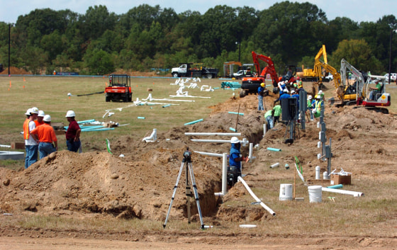 Workers begin digging sewer and water lines on a 60 acre plot of land in Baker, La., on Saturday, Sept. 18, where FEMA plans to put trailers for displaced families from Hurricane Katrina. 
