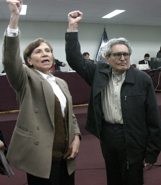 Abimael Guzman, the founder of Peru’s Shining Path guerrilla movement, right, and Elena Iparraguirre, his cellmate and longtime aide and lover, raise their arms at Guzman's trial in this November 2004 file photo. The proceeding ended in a a chaotic mistrial.