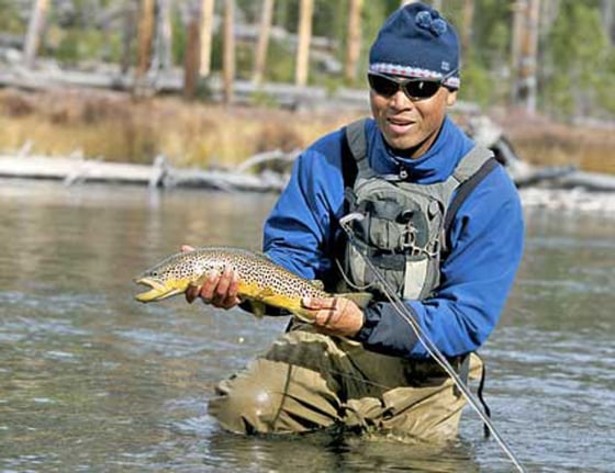 Dylan displays one of the nine brown trout he pulled out of the Lewis Channel in less than three hours, earning him the coveted bottle of Jim Beam.