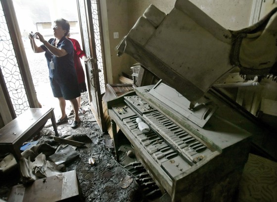 Lina Nunez photographs her Saint Bernard Parish home destroyed by flood damage in New Orleans