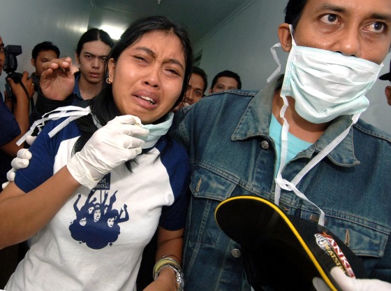 A woman breaks down in tears at a hospit