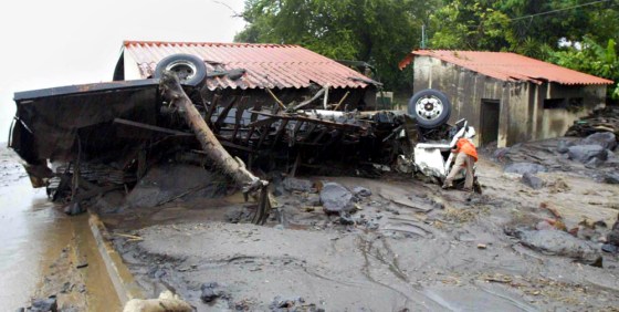 Remains of a truck lie on the side of a road in Planes de la Laguna, El Salvador, on Monday. A tropical weather front swept over Central America, unleashing downpours and causing rivers to overflow.