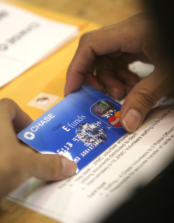 Official holds FEMA debit card inside Reliant Arena
