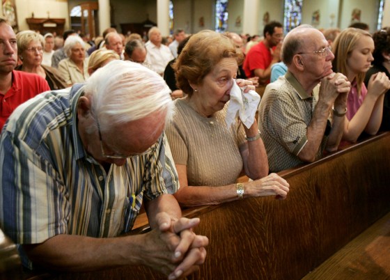 Anna Maria Mitchell, second left, wipes her eyes as she and her husband, Donald Mitchell, left, on Sunday attend the first Mass at the historic St. Louis Cathedral since Hurricane Katrina hit more than a month ago.