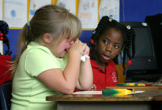 New student evacuee Magan Franklin, left, is comforted Monday by another first grade student, Derrius Richardson, who was already at Harahan Elementary, in Louisiana.