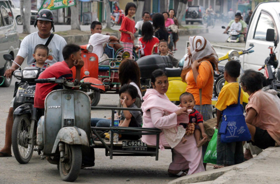 Local residents prepare to flee from their house after the earthquake in Banda Aceh on Wednesday.