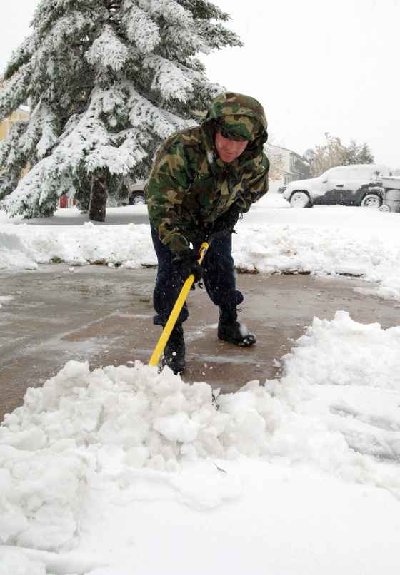 Senior Airman Kevin O'Reilly clears his base housing driveway at Minot Air Force Base in North Dakota on Wednesday.