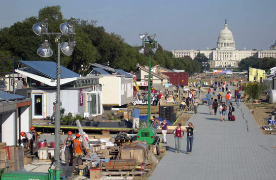 Congress is seen in the distance as a solar village is built on the National Mall this week by university teams competing in the 2005 Solar Decathlon.