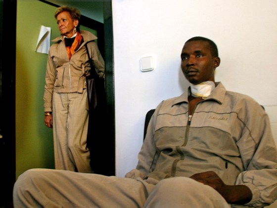 Spain's Deputy PM Fernandez de la Vega walks past a would-be immigrant in Spain's north African enclave of Ceuta