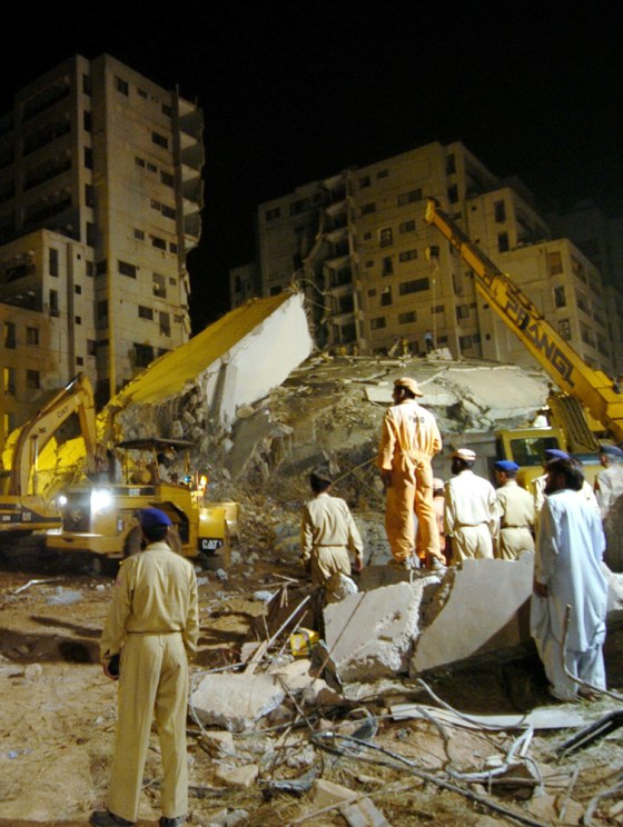 Pakistani rescuers remove debris from th
