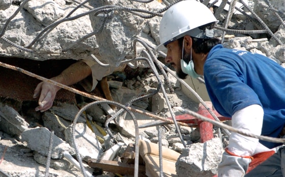 A Pakistani rescuer approaches the hand