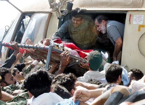 Earthquake victims are loaded onto a Pakistani army helicopter in Muzaffarabad