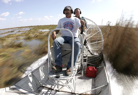Pilot Richard pilots his airboat past the tall rush grass of the Rockefeller Wildlife Refuge outside Cameron