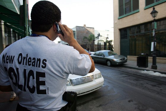 A New Orleans police officer surveys Bourbon Street in the French Quarter of New Orleans on Monday. Home for most officers is a cramped cruise ship, and work is 12- to 14-hour days in a wrecked city.