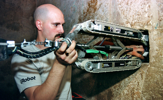 The shafts were last probed in September 2002. In this photo from that project, Gregg Landry, an engineer from the Boston firm iRobot, places a robot inside the shaft of the Great Pyramid in Cairo. The new robot has been designed by a university in Singapore.