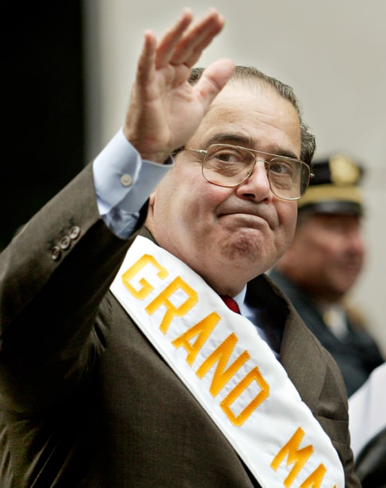 Supreme Court Justice Antonin Scalia waves to the crowd Monday in his role as grand marshal for the 61st Annual Columbus Day Parade in New York City.