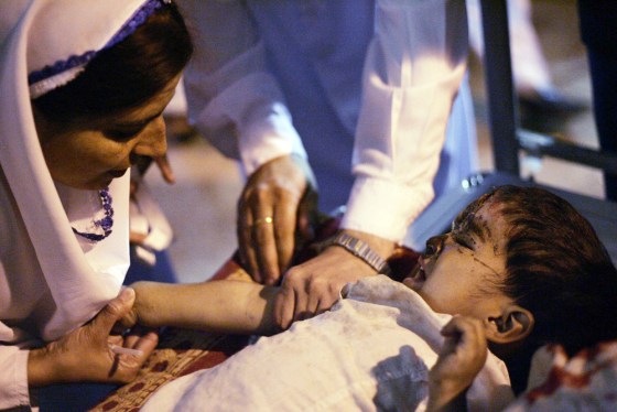 A doctor treats an earthquake victim in the northern Pakistani town of Abbottabad, on Monday.