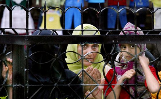Muslim devotees offer prayers for the earthquake victims in Srinagar, India, on Tuesday. The earthquake has killed and displaced thousands of people, including Kashmir militants.