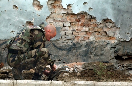 A French soldier from the International Security Assistant Force checks one of two rockets fired in Kabul, Afghanistan on Wednesday. The attacks came hours before a visit by the U.S. Secretary of State Condoleezza Rice.