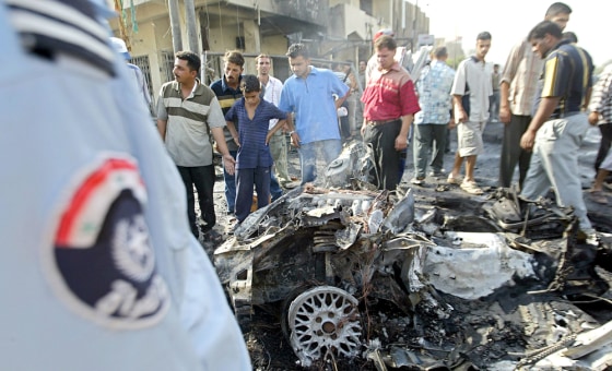 Iraqis gather at the site where a suicid