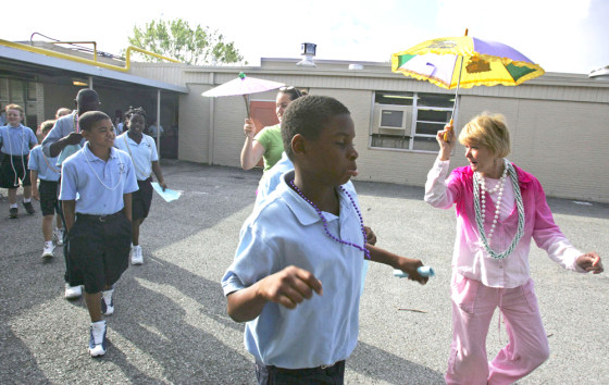 Teacher's assistants lead fourth and fifth graders to class on first day of school since Hurricane Katrina hit in Louisiana