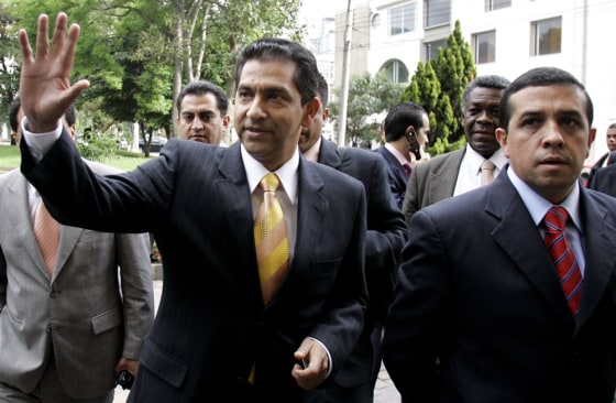 Former Ecuadorean President Lucio Gutierrez waves Thursday as he arrives to make a formal announcement of his plans at a news conference in Bogota, Colombia.