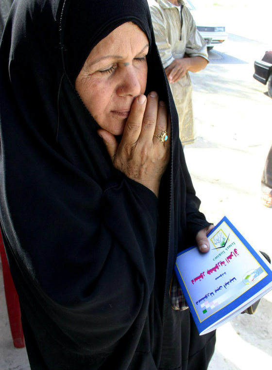 An Iraqi woman holds a copy of the draft