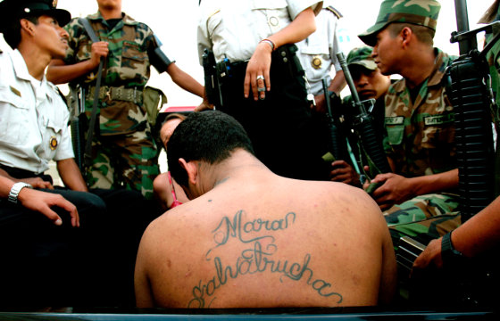 A member of the Mara Salvatrucha gang is detained by army and police in Guatemala City on July 20. A string of violent killings targeting gang members and criminals in Guatemala has prompted rumors of a "social cleansing."