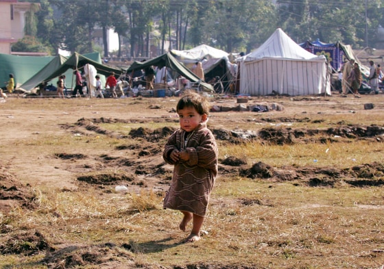 A boy walks at a tent village in Muzaffarabad
