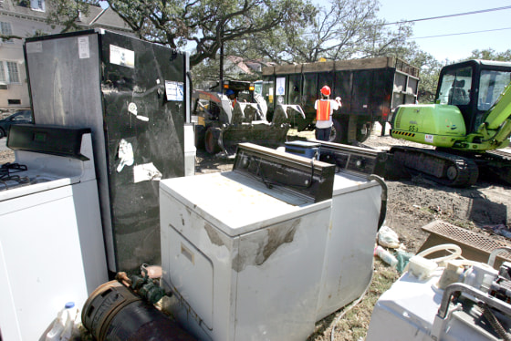 Home appliances damaged by Hurricane Katrina sit in front of homes in New Orleans on Tuesday. Residents are placing damaged items along the streets for pickup.