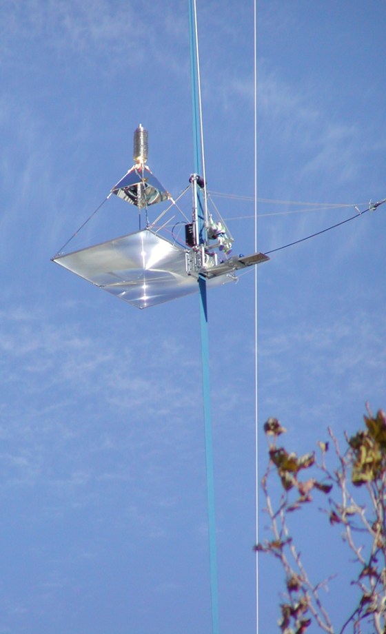 A robot climber makes its way up a thin tether suspended from a crane during Sunday's Beam Power Challenge at the NASA-backed Space Elevator Games in Mountain View, Calif.
