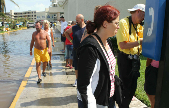 Foreign tourists wait in line to make a