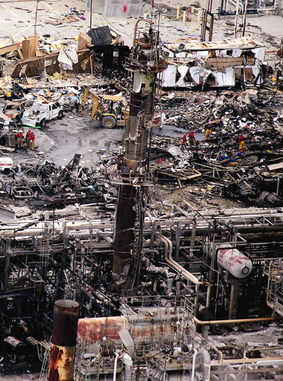 Workers sift through debris at the BP fa