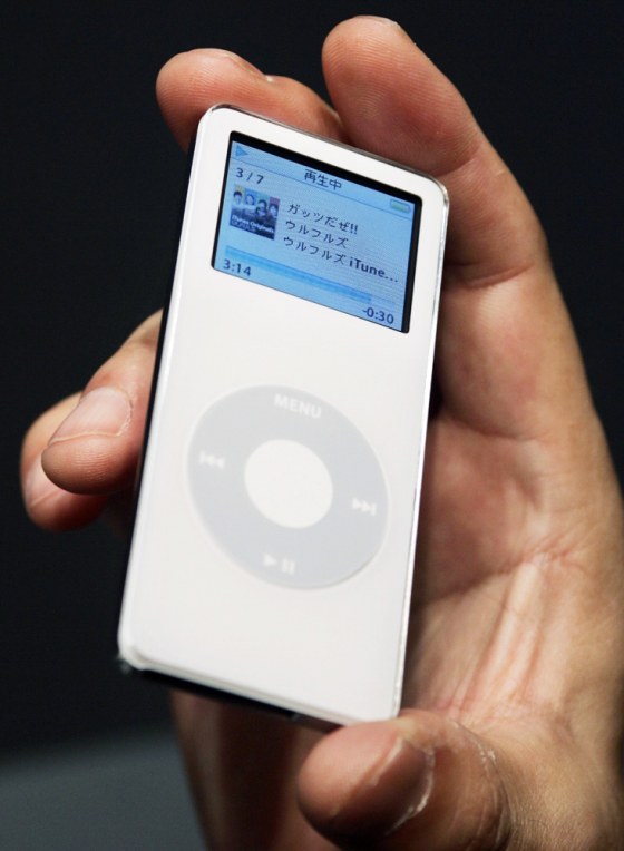 An Apple Computer Inc employee holds the new digital music player iPod Nano at a news conference in Tokyo