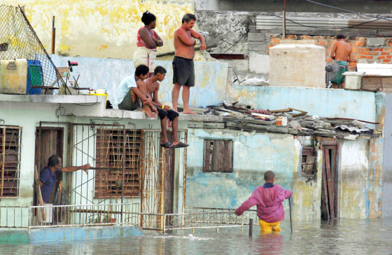 Local residents sit 24 October, 2005 in