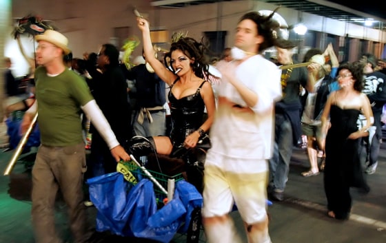 Someone calling herself Queen Katrina, center, leads a Halloween parade in the French Quarter of New Orleans on Saturday.