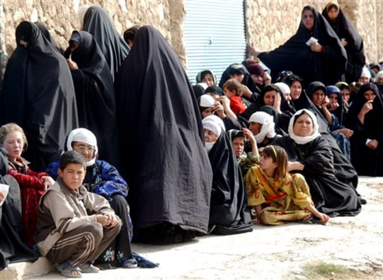 People line up at a check point in the northern Iraqi city of Mosul on Sunday.