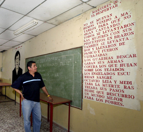 Julio Cesar Mendez, 42, reads a poem written on a wall at the "El Despertar" Catholic home of retirees in San Salvador, where a priest and four youths were assassinated by the army at the beginning of El Salvador's civil war in January 1979.