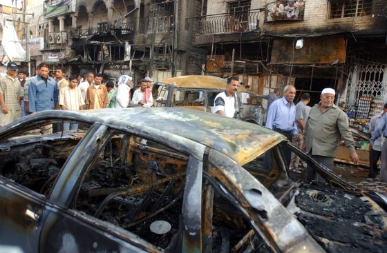 Residents survey burned cars Tuesday, a day after a powerful roadside bomb exploded in Basra, Iraq.