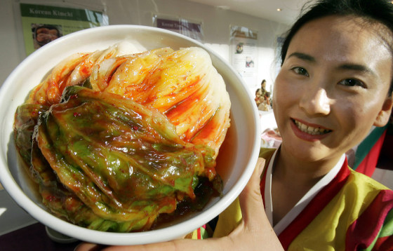 A woman in traditional Korean dress hold