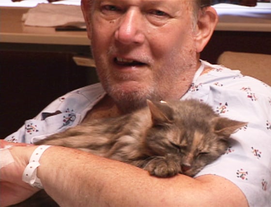 Bill Harris is shown holding Miss Kitty after being reunited with his beloved cat, Miss Kitty, in September.