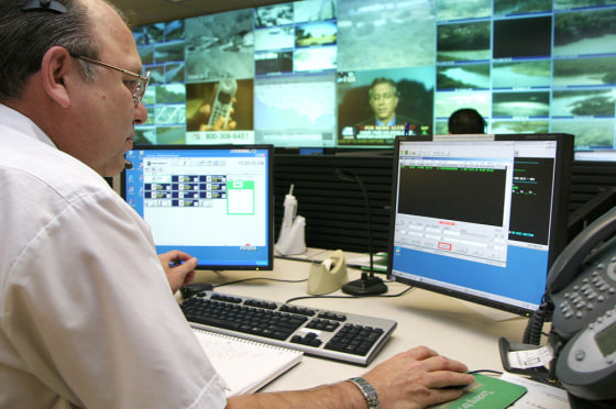 US Border Patrol communications assistant monitors video screens at border patrol station in Laredo, Texas