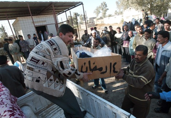 The coffin of a victim of a suicide bomber is loaded Thursday on a small truck outside Mahmoudiya's hospital morque. The blast outside the hospital killed 30 people and wounded 35 more.