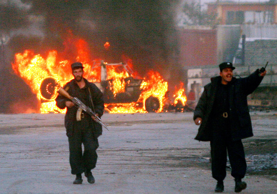 Police officers secure the area in front of a burning international peacekeeper vehicle after a suicide attack in Kabul, Afghanistan, on Nov. 14.