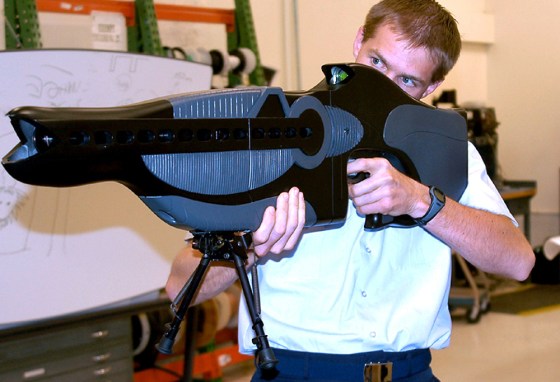 U.S. Air Force Capt. Drew Goettler, at Kirtland Air Force Base, N.M., demonstrates a prototype hand held laser device developed as a non-lethal weapon intended to "dazzle" a potential enemy by temporarily impairing a person's ability to see.