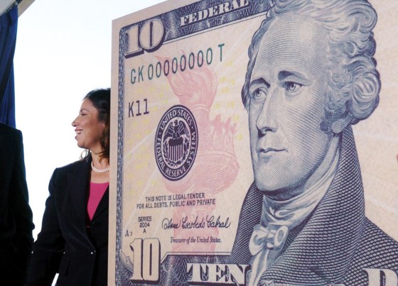 U.S. Secretary of the Treasury John Snow and U.S. Treasurer Anna Escobedo Cabral talk near a sample ten dollar note