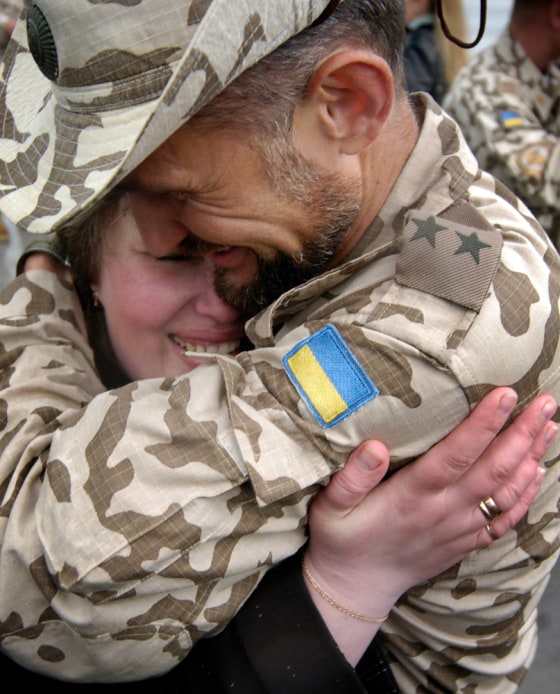 A Ukrainian soldier embraces his wife after returning from Iraq outside the Ukrainian capital of Kiev in May. Key U.S. allies Bulgaria and Ukraine will begin withdrawing their troops by mid-December.