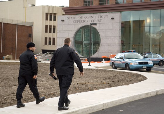 Police sweep the courthouse in Stamford, Conn., on Friday after a bomb threat was called in to the governor's office.