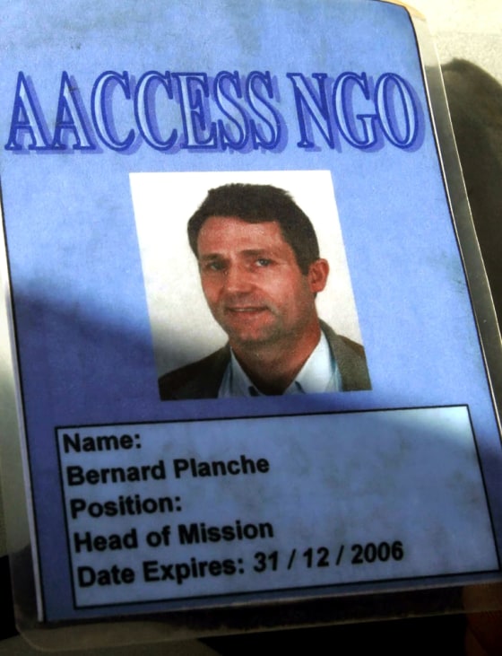 A policeman holds the identification car